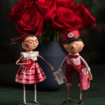 Whimsical handmade doll figures with red roses, perfect for Valentine's Day decor.